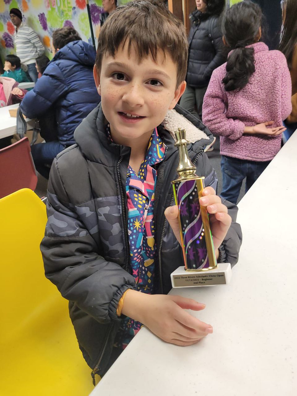 Student with chess trophy